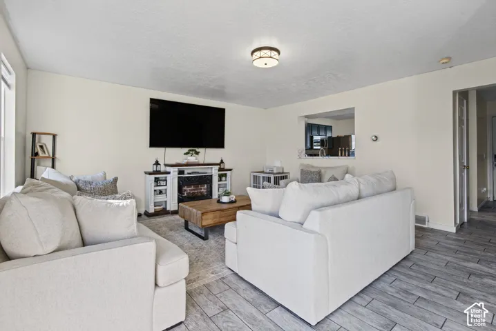 Recessed wall opening, decorative ceiling light fixture, and wood-finish flooring