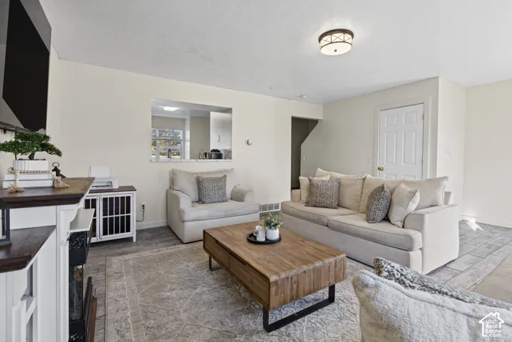 Recessed ceiling lighting, a pass-through window, and wood-finish flooring