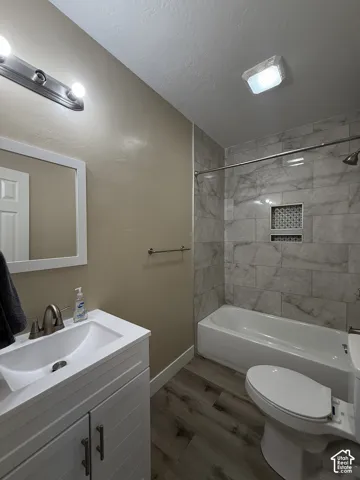 White vanity with brushed nickel hardware, integrated sink, and brushed nickel faucet