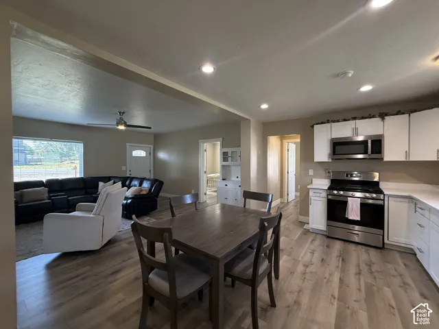 Kitchen featuring white cabinetry, stainless steel appliances, and light-toned countertops