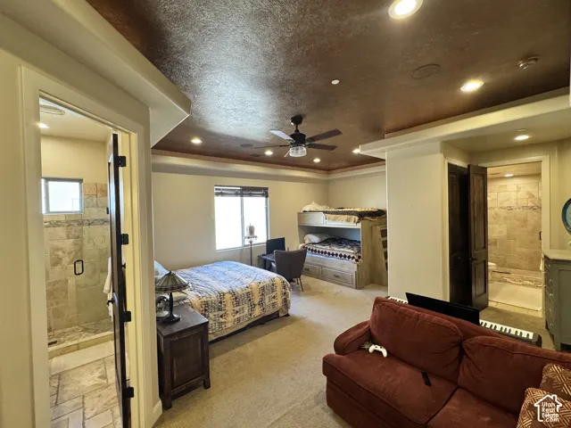 Tray ceiling with recessed lighting and ceiling fan, carpeted flooring, and a window with blinds