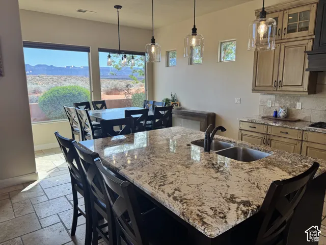 Kitchen island with integrated sink, black faucet, and ample counter space