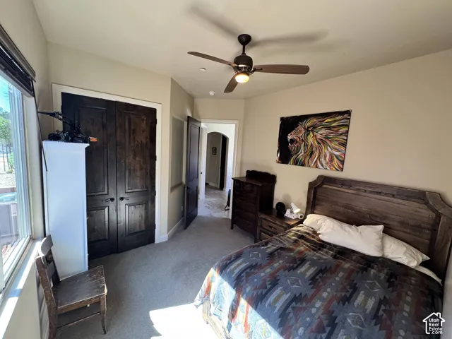 Recessed lighting, ceiling fan with integrated light, carpeted flooring, and dark wood-finish bi-fold closet doors