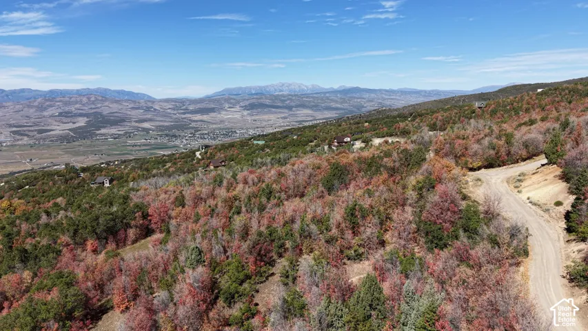 Mountainous terrain featuring expansive natural landscaping and distant valley scenery