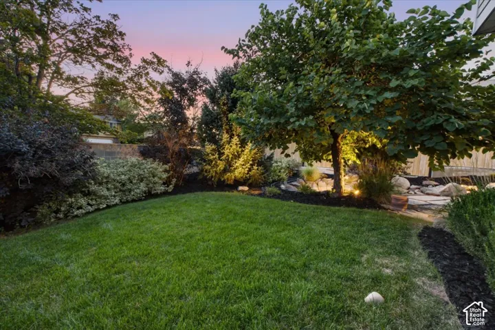 Manicured lawn with mature trees and established landscaping