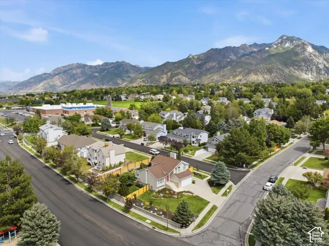 Residential neighborhood with established landscaping and mountain backdrop