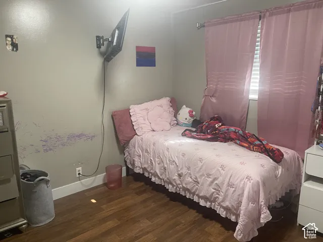 Wood-finish flooring with a wall-mounted television bracket