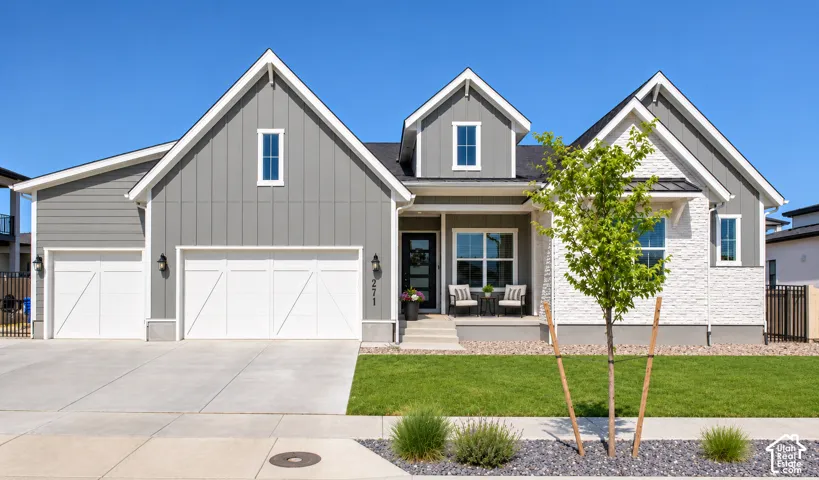 Contemporary residence featuring a combination of gray siding and white stone-finish facade