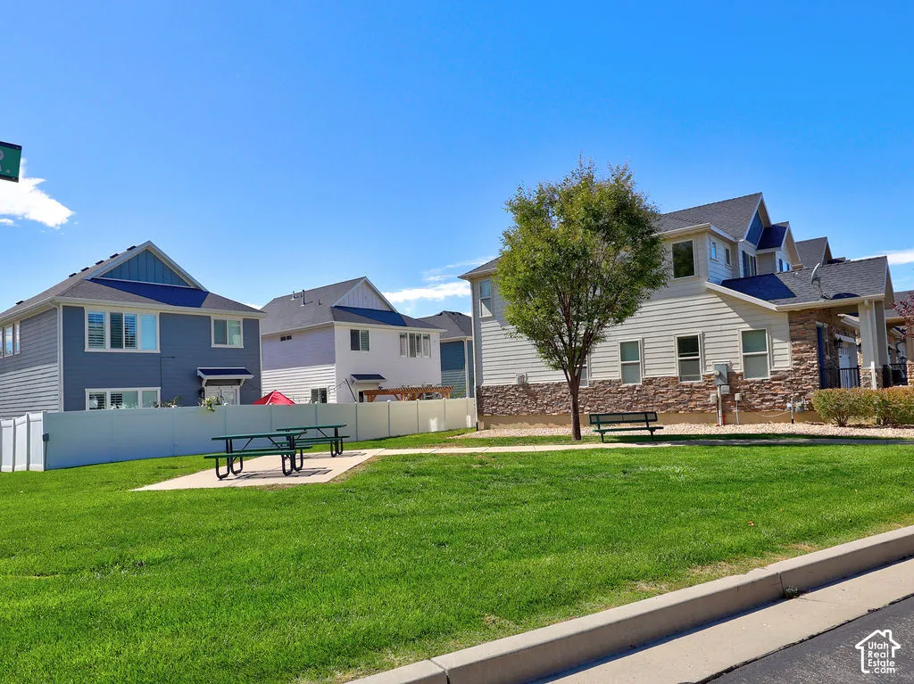 Common area featuring a manicured lawn, concrete pads, and professional landscaping