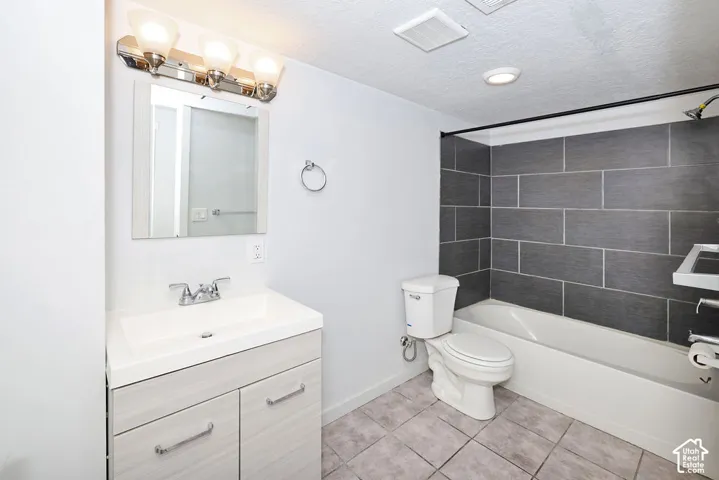 Vanity with integrated sink, chrome faucet, and a rectangular mirror