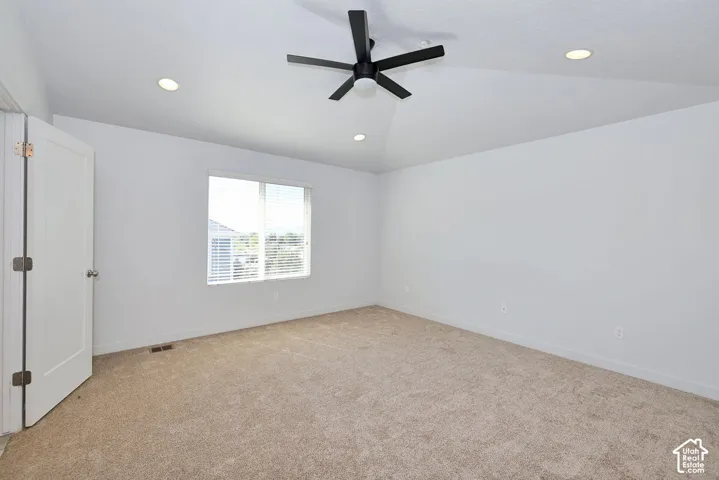 Recessed lighting fixtures, a ceiling fan, a window with blinds, and carpeted flooring