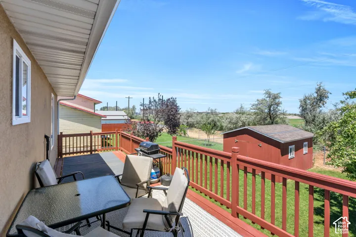 Spacious outdoor deck with a red railing and a contrasting dark surface
