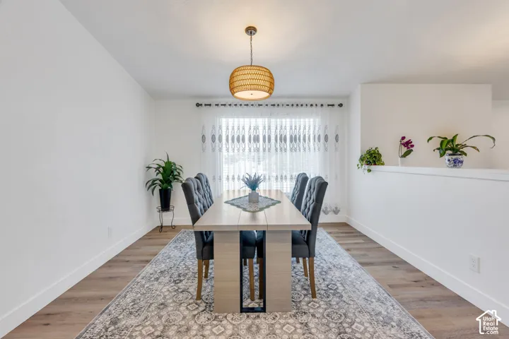 Wood-finish flooring, white walls, and a contemporary ceiling light fixture