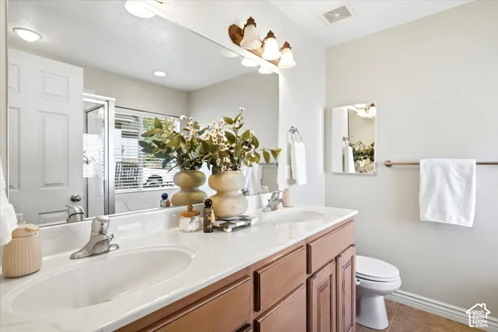 Double vanity with integrated sinks and a light-toned countertop