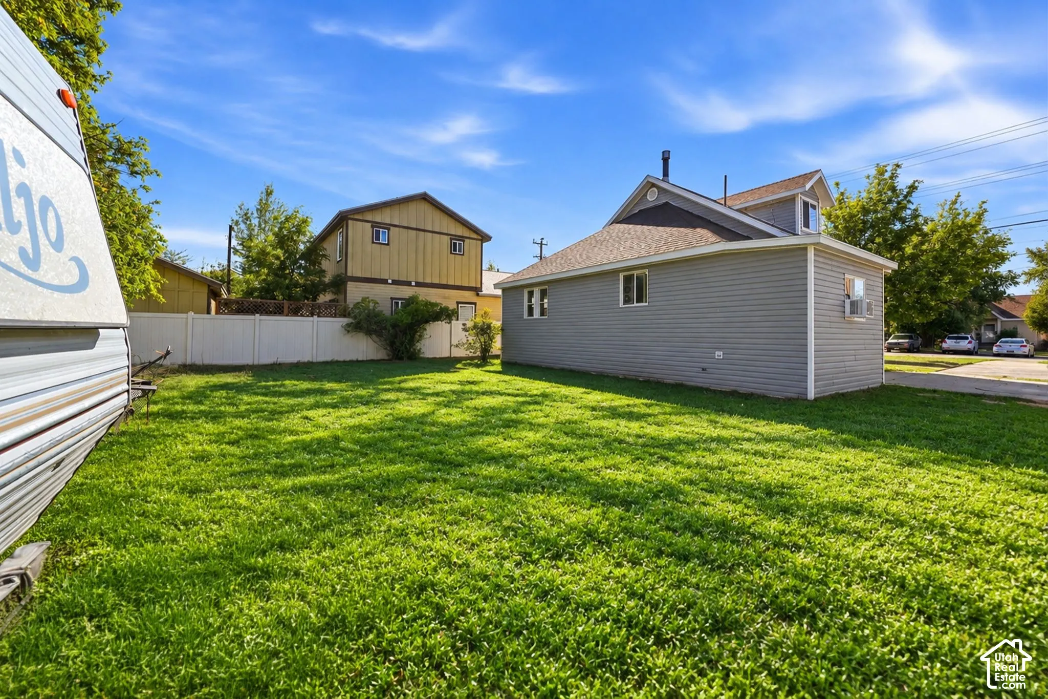 Spacious lawn area with a privacy fence