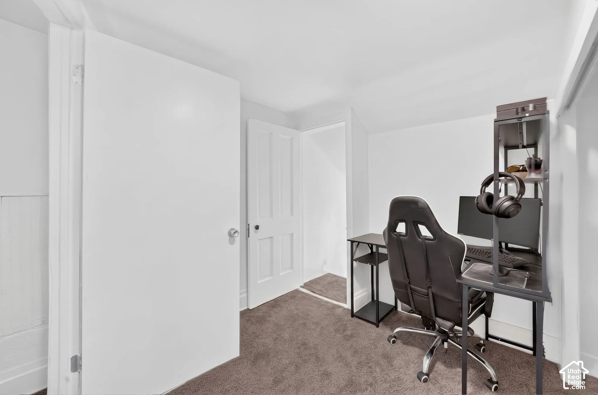 White walls and brown carpet flooring