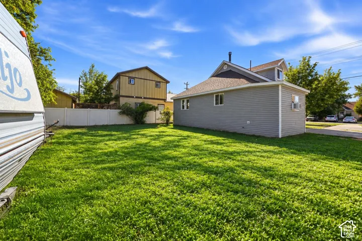 Spacious lawn area with a privacy fence