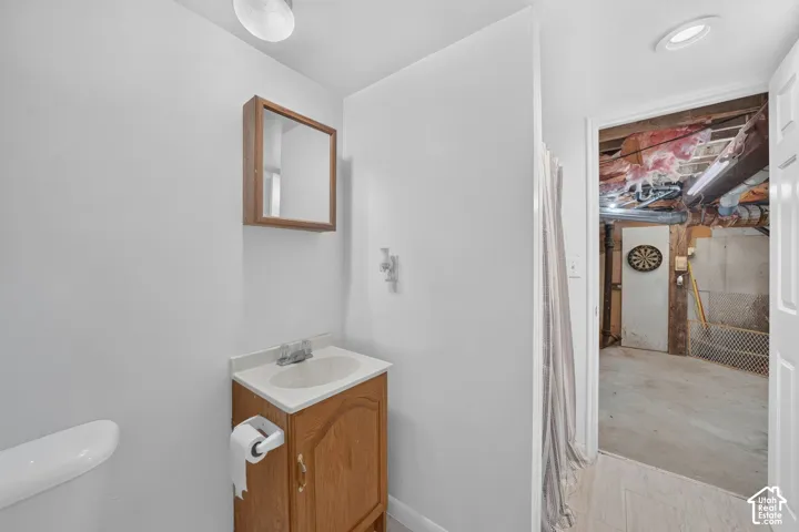 Wood-finish vanity with a white countertop and integrated sink