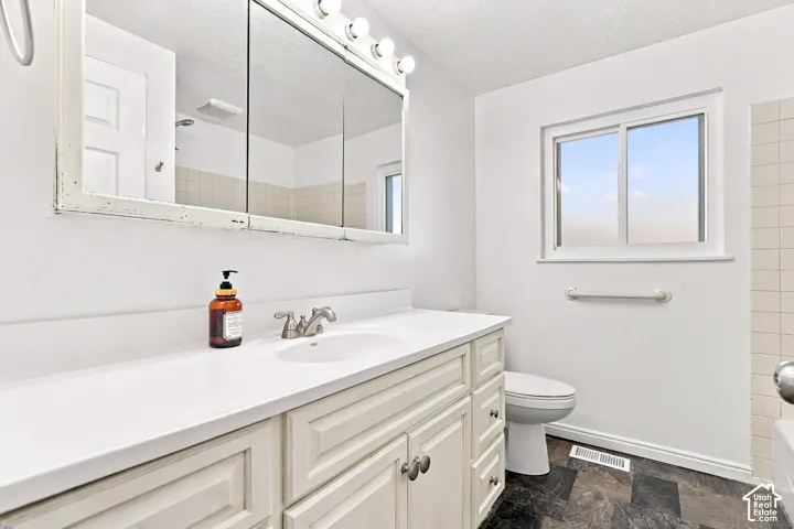 White vanity with panel detailing, integrated sink, and brushed nickel faucet