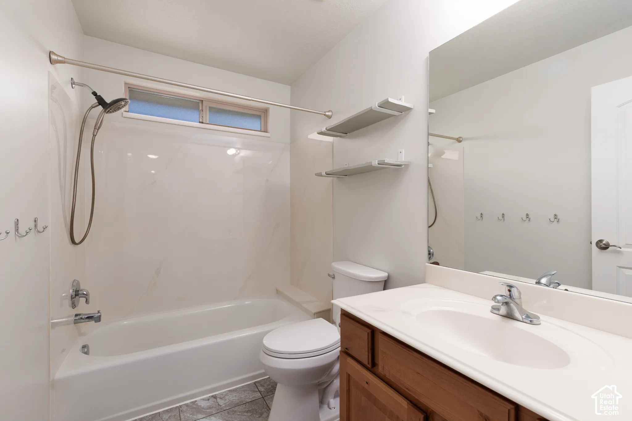 Bathtub with a shower head and overhead window