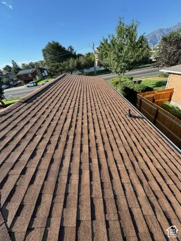 Brown architectural shingle roofing with a visible gutter system