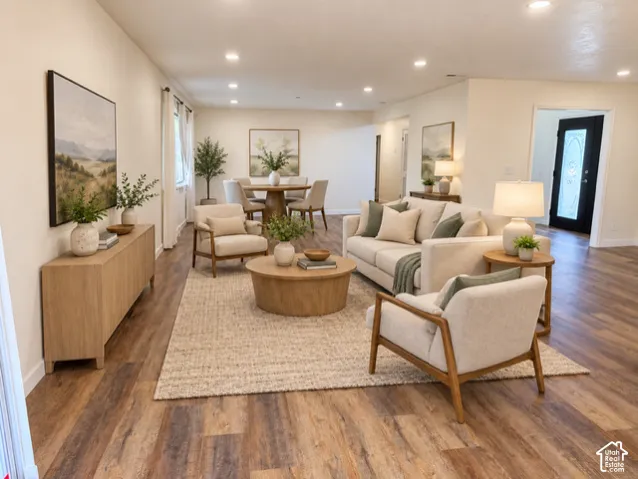 Recessed lighting, wood-finish flooring, and light-toned walls