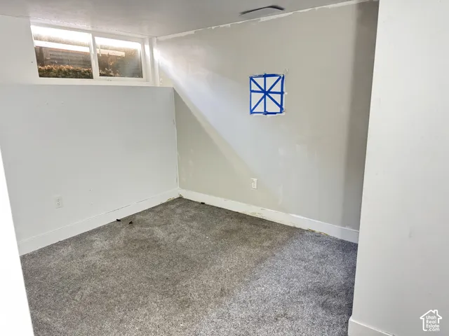 Wall-to-wall carpeting with light-colored walls and baseboards