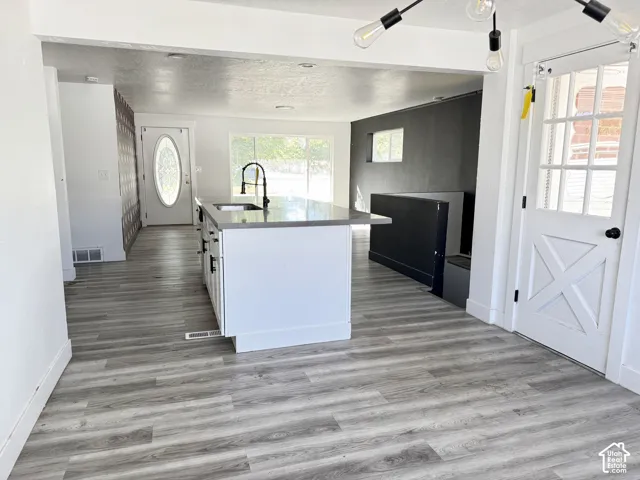Kitchen island with a light-toned countertop and dark hardware