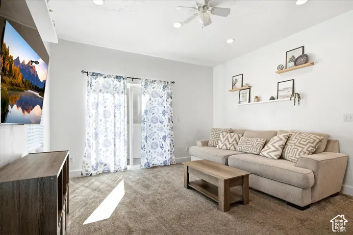 Recessed lighting, ceiling fan, white walls, and carpeted flooring