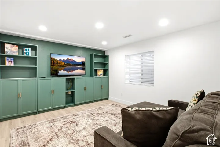 Built-in shelving and cabinetry with brass hardware