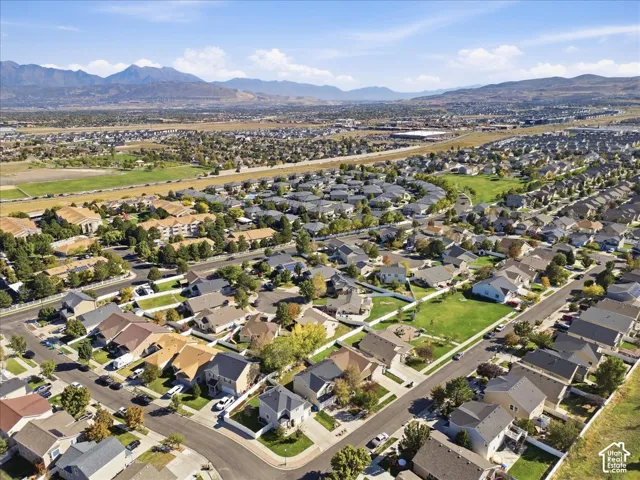 Residential properties featuring pitched roofs and varied exterior finishes, surrounded by green spaces and mature trees