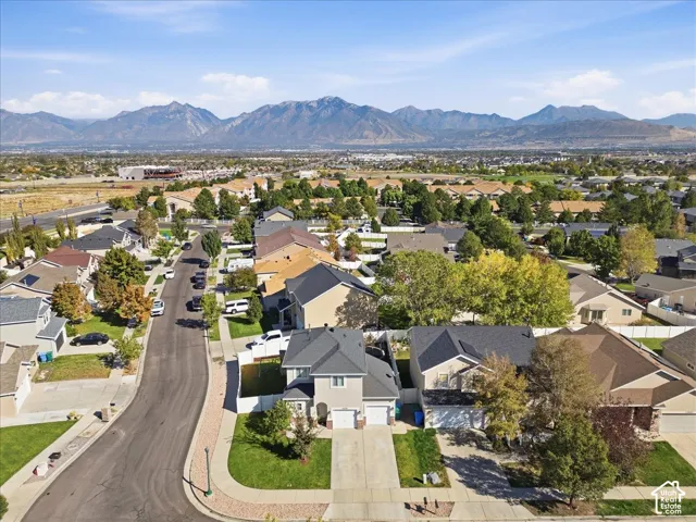 Residential neighborhood with established homes, mature trees, and a mountain backdrop