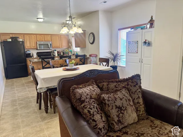 View 2 Kitchen featuring wood-finish cabinetry, stainless steel microwave, and tile flooring