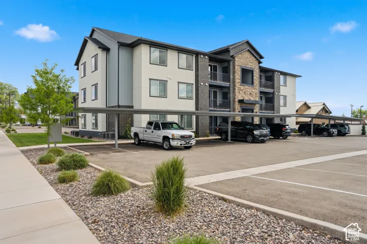 Multi-story building featuring a stone facade and gray siding