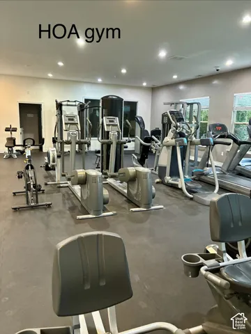 Fitness center featuring a variety of exercise equipment, recessed lighting, and wall-mounted blinds
