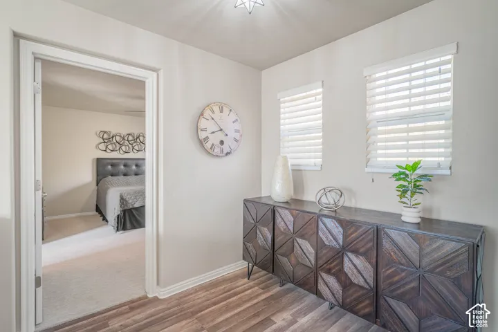 Wood-finish flooring with light-toned walls and multiple windows