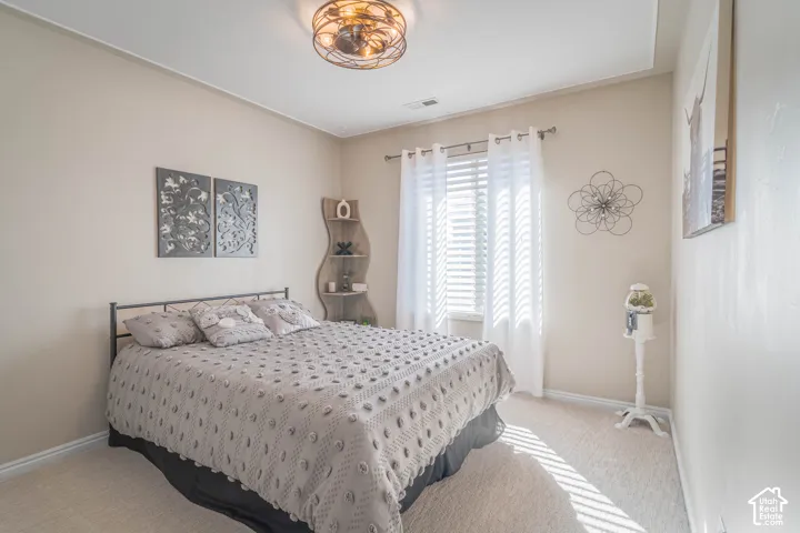 Recessed window with white blinds and sheer curtains, complemented by a decorative ceiling light fixture