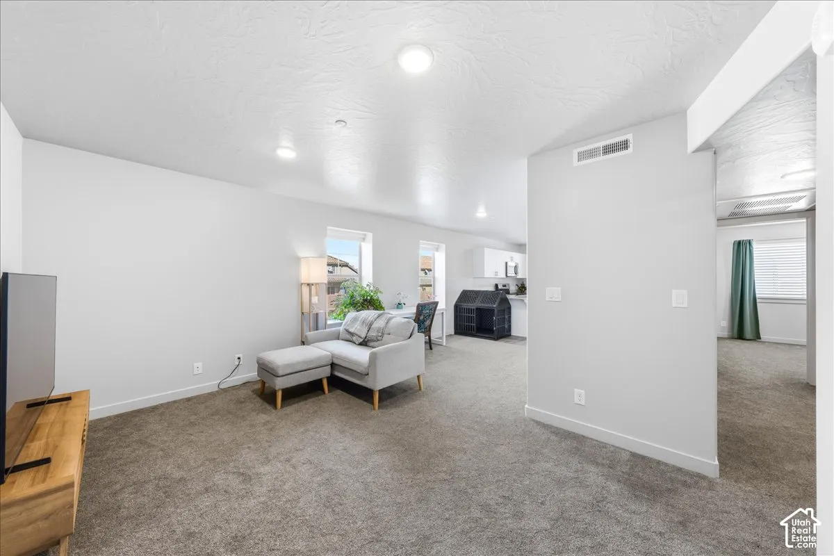 Recessed lighting, wall-to-wall carpeting, and bright white walls