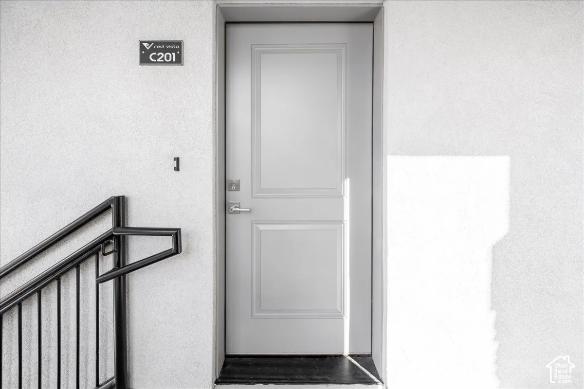 Panel door with brushed nickel hardware and black threshold