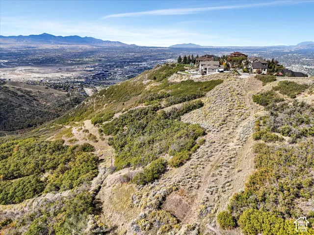 Mountainous terrain with established homes on a distant ridge