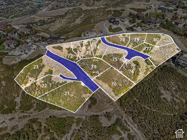 Aerial perspective showcasing multiple land parcels within a developed residential area