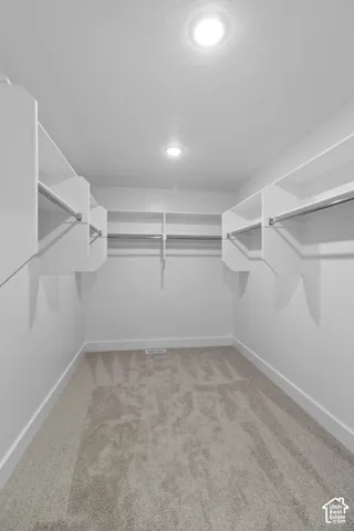 Primary bedroom walk-in closet
