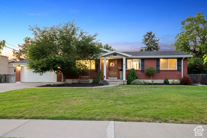 Red brick exterior with white trim and a covered entry.