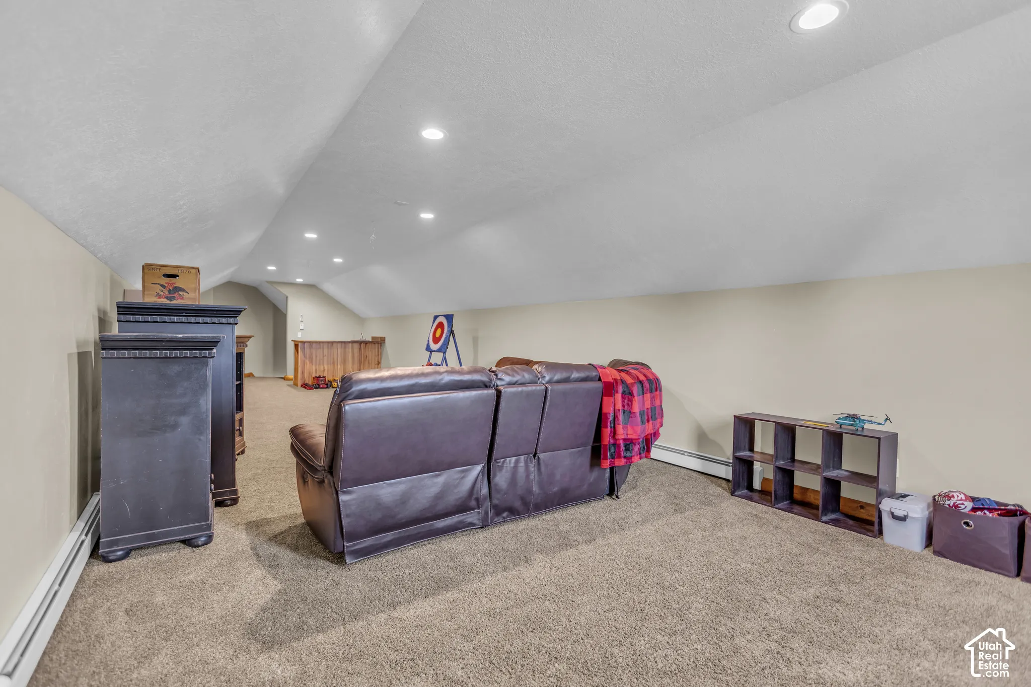 Carpeted space with recessed lighting and sloped ceilings