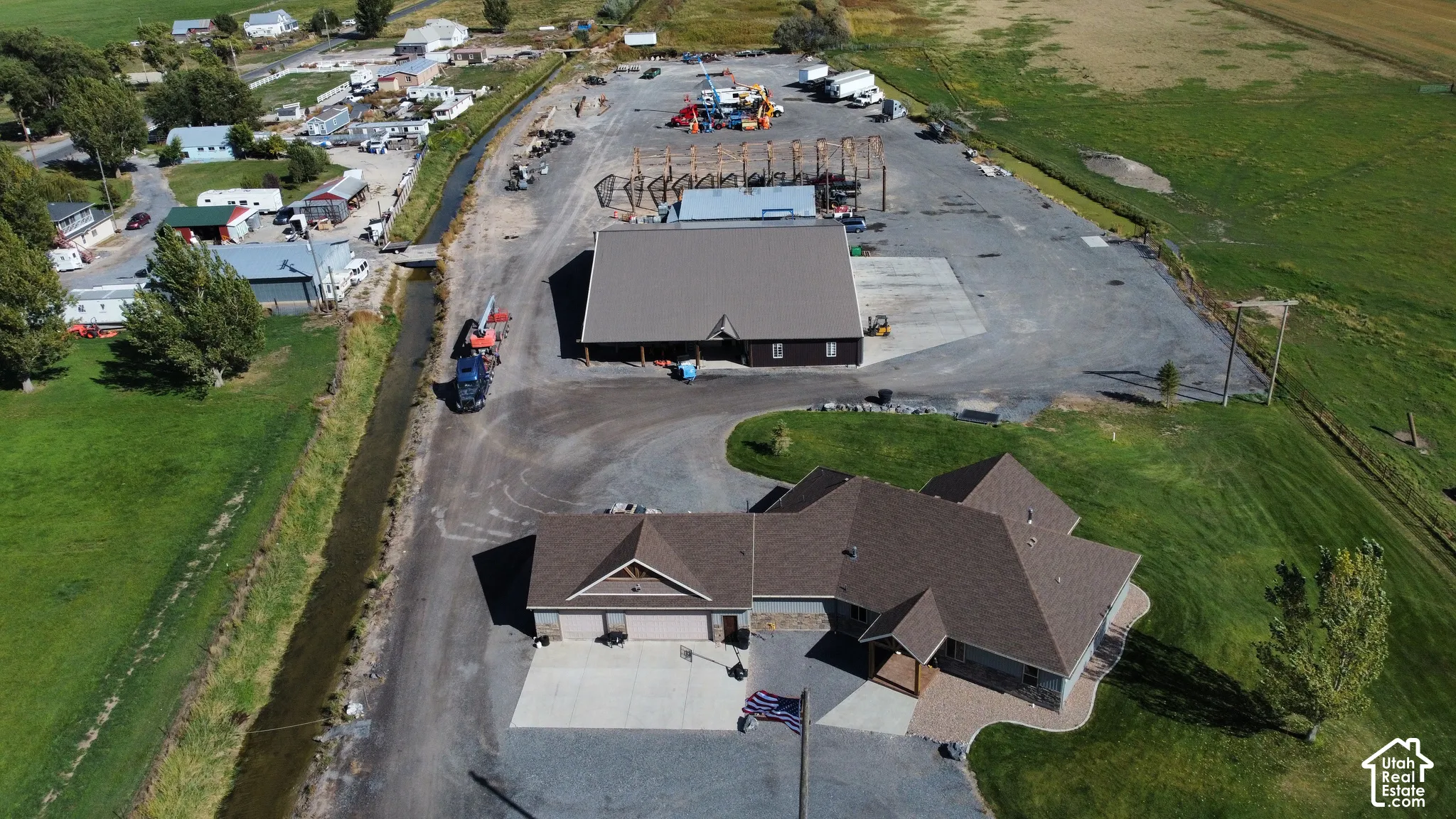 Asphalt shingle roof residence with an attached garage, paver stone walkway, and a gravel driveway
