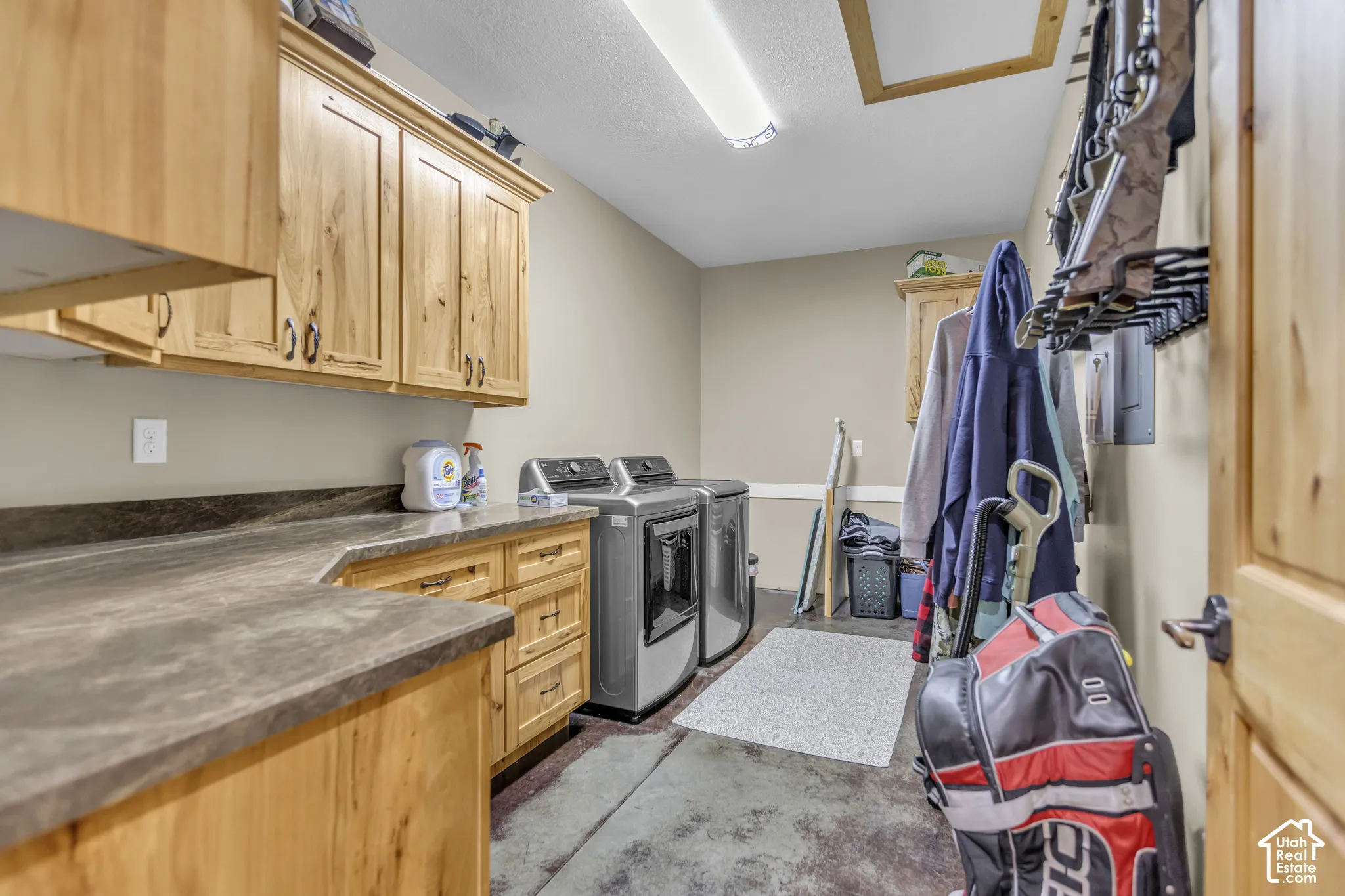 Built-in wooden cabinetry, ample countertop space, and a ceiling-mounted light fixture