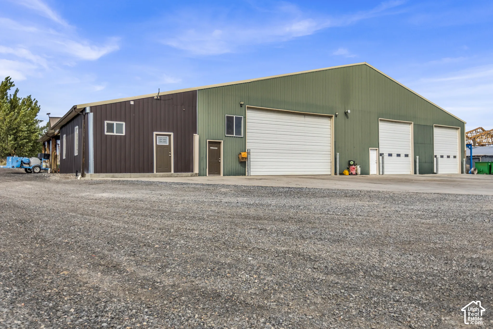 Metal-sided commercial building with a gravel lot