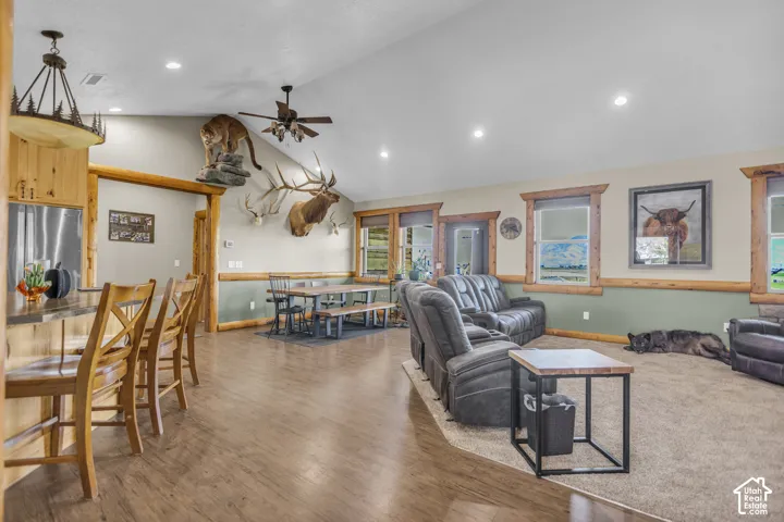 Vaulted ceiling with recessed lighting and a ceiling fan