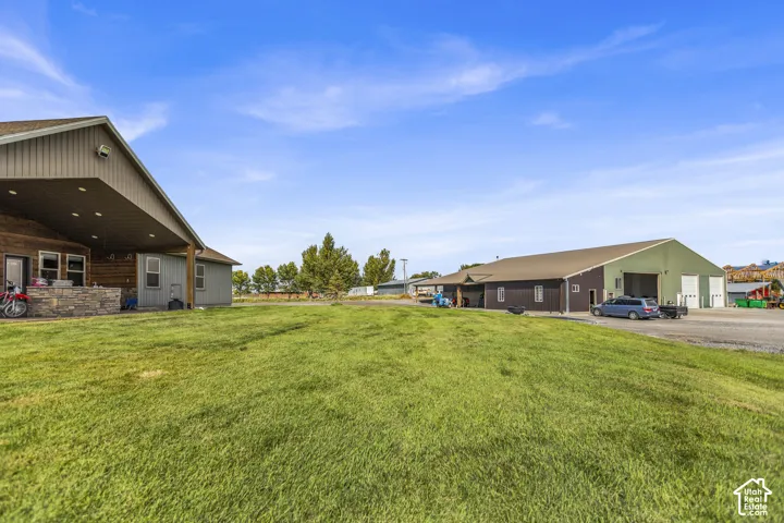 Expansive green space with an adjacent gravel parking area