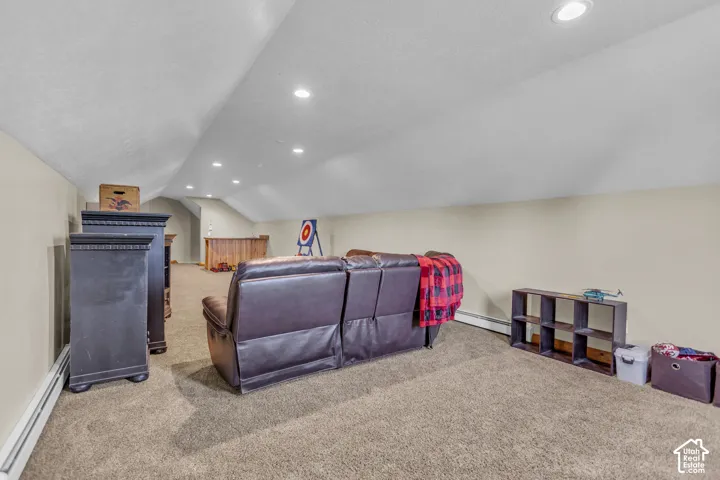 Carpeted space with recessed lighting and sloped ceilings